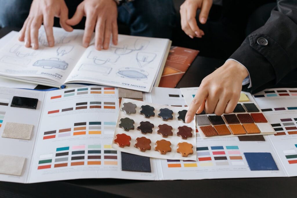 pexels-photo-6648439 Designers reviewing color swatches and sketches for project planning.